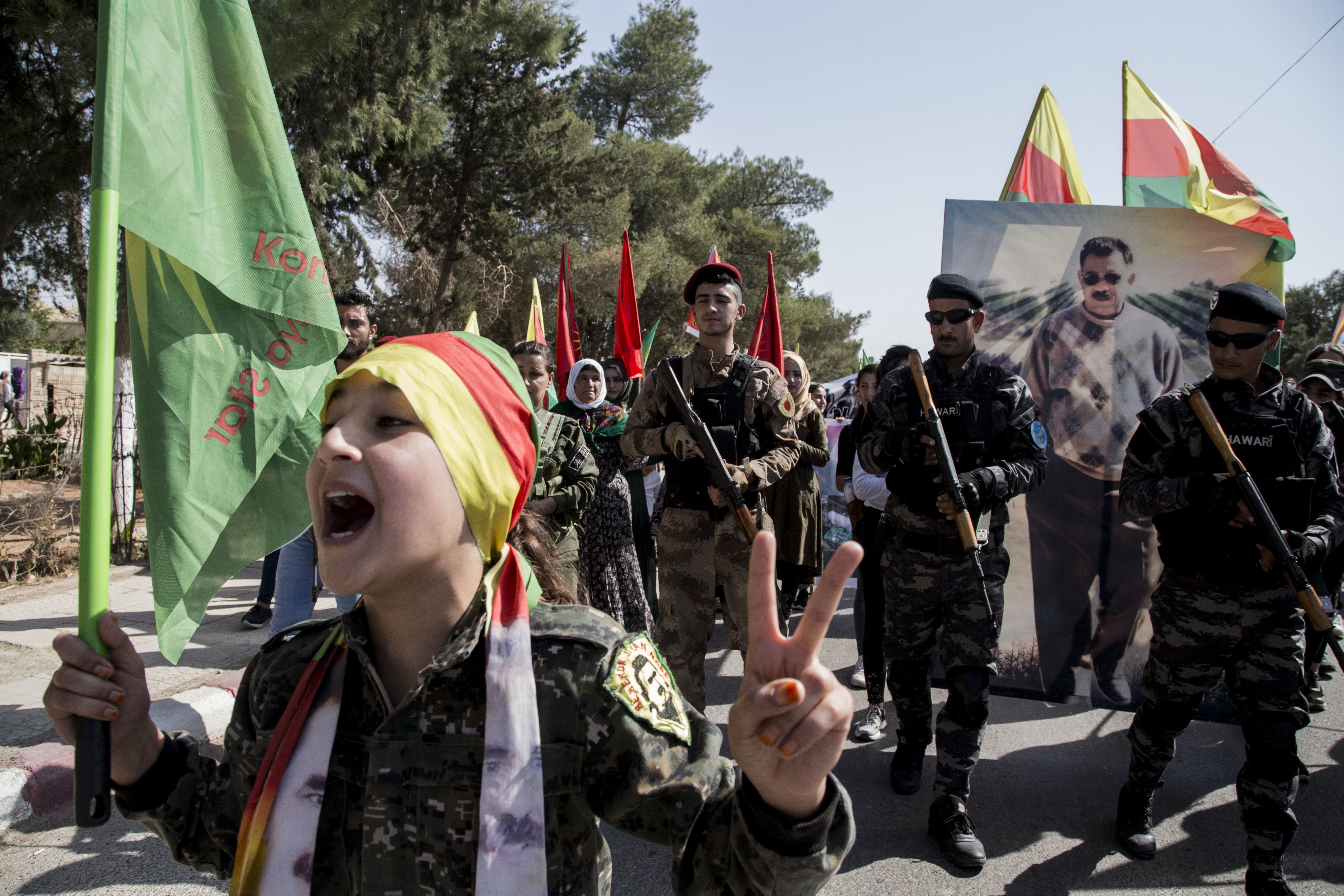 Fighters of the Syrian Democratic Forces march during a demonstration against possible Turkish military operations. Photo: AP
