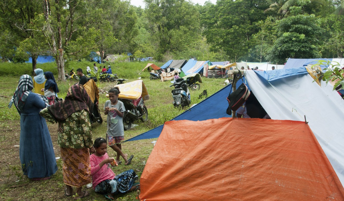 Earthquake survivors stand near their tents at a temporary shelter in Ambon, Maluku province. Photo: AP