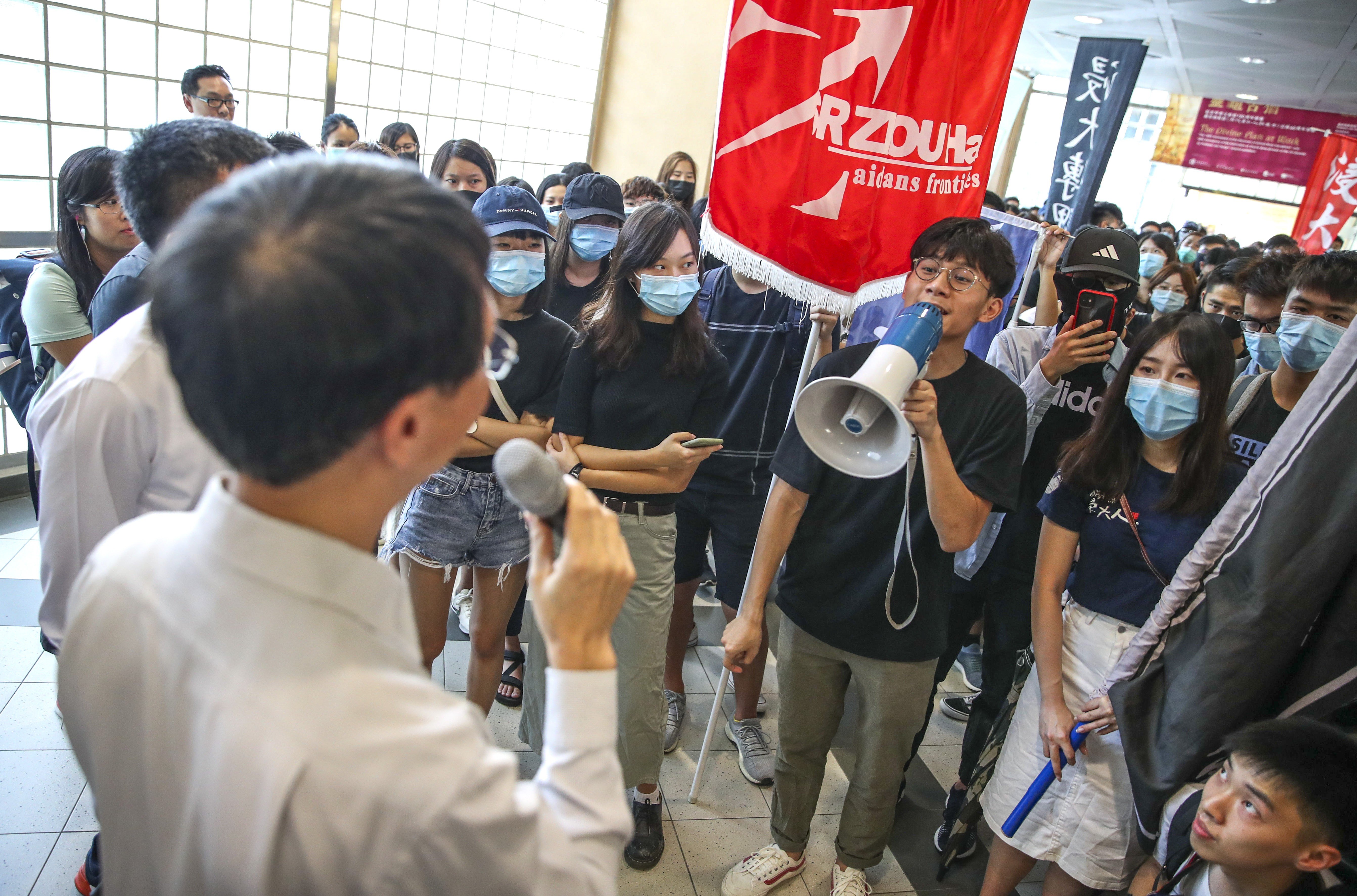 Students at Baptist University stage a protest on Tuesday over the arrest of five undergraduates. Photo: Winson Wong