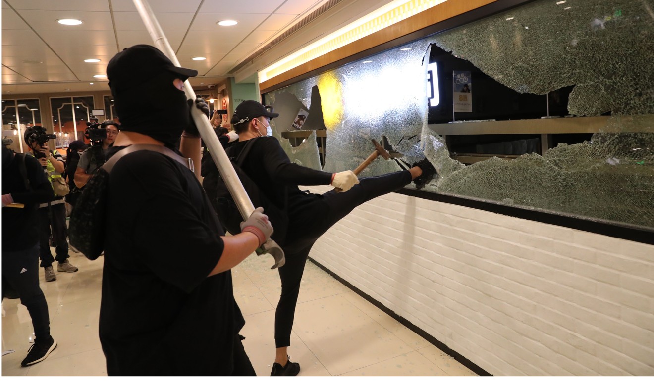 Protesters vandalise a restaurant in City One shopping mall. Photo: Sam Tsang