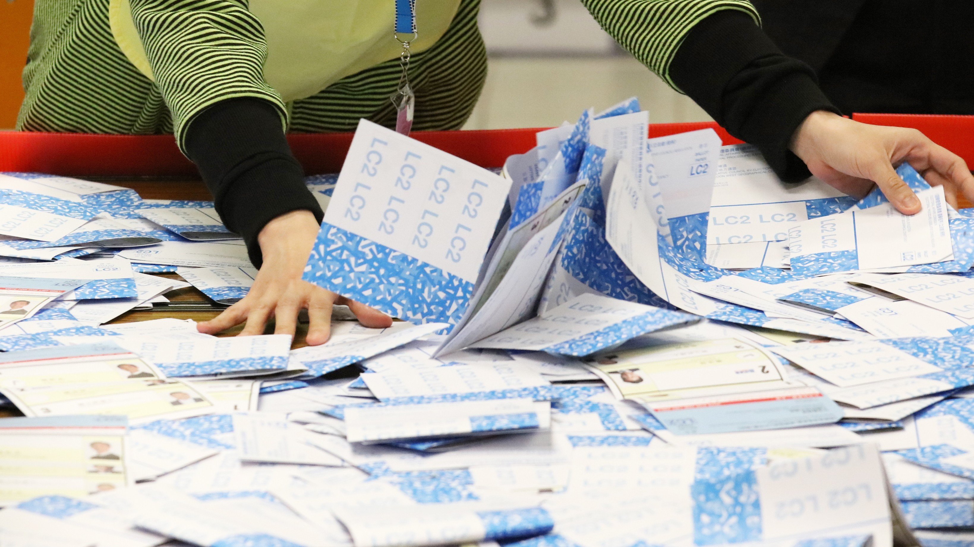 Voting slips are gathered at a counting station during the 2018 Legislative Council by-election. Photo: Felix Wong