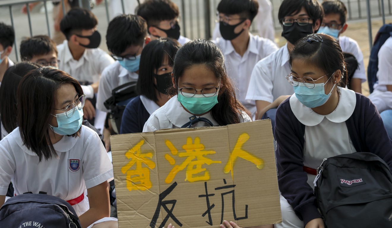 Students wear masks during a protest outside Shau Kei Wan government secondary school. Photo: Xiaomei Chen