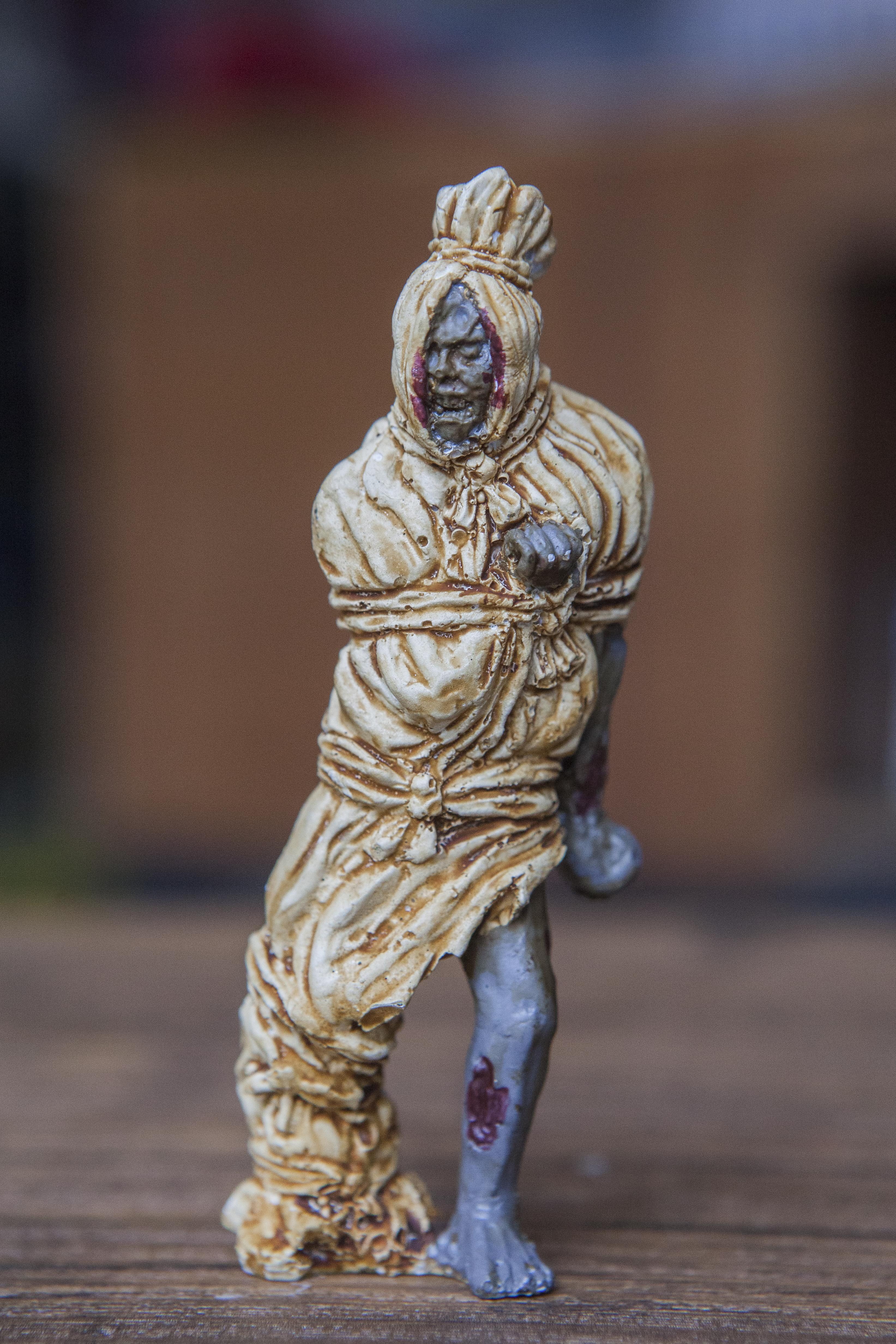 A figurine of a dead body wrapped in a shroud, made by GoodGuysNeverWin. Photo: Agoes Rudianto