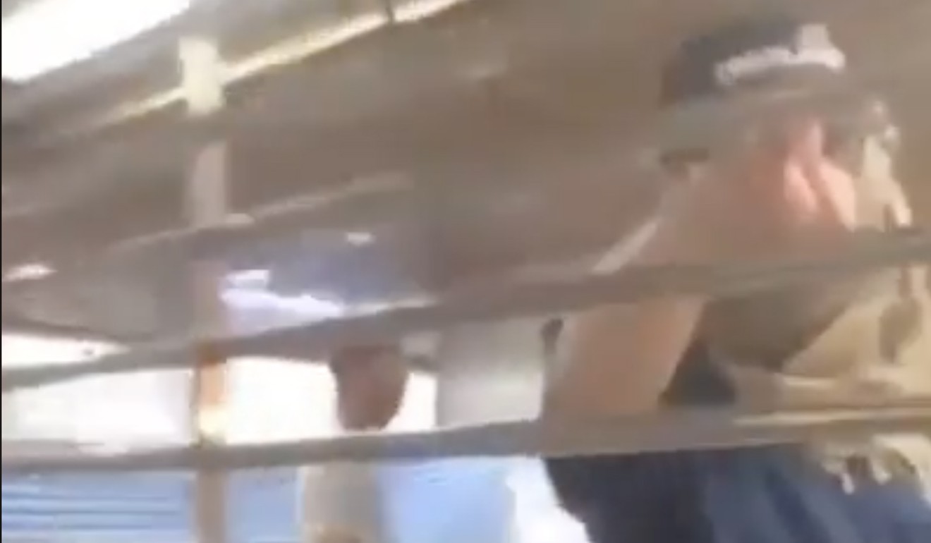 A screen grab of a viral video shows a police officer standing inside Sheung Shui MTR station. Photo: Facebook