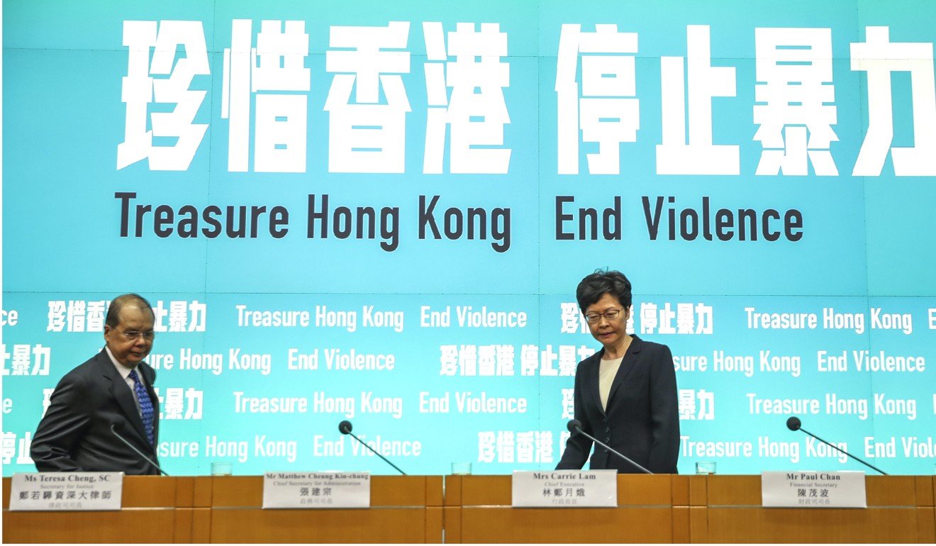 Carrie Lam, with Matthew Cheung, at a news briefing to announce the mask ban. Photo: Winson Wong