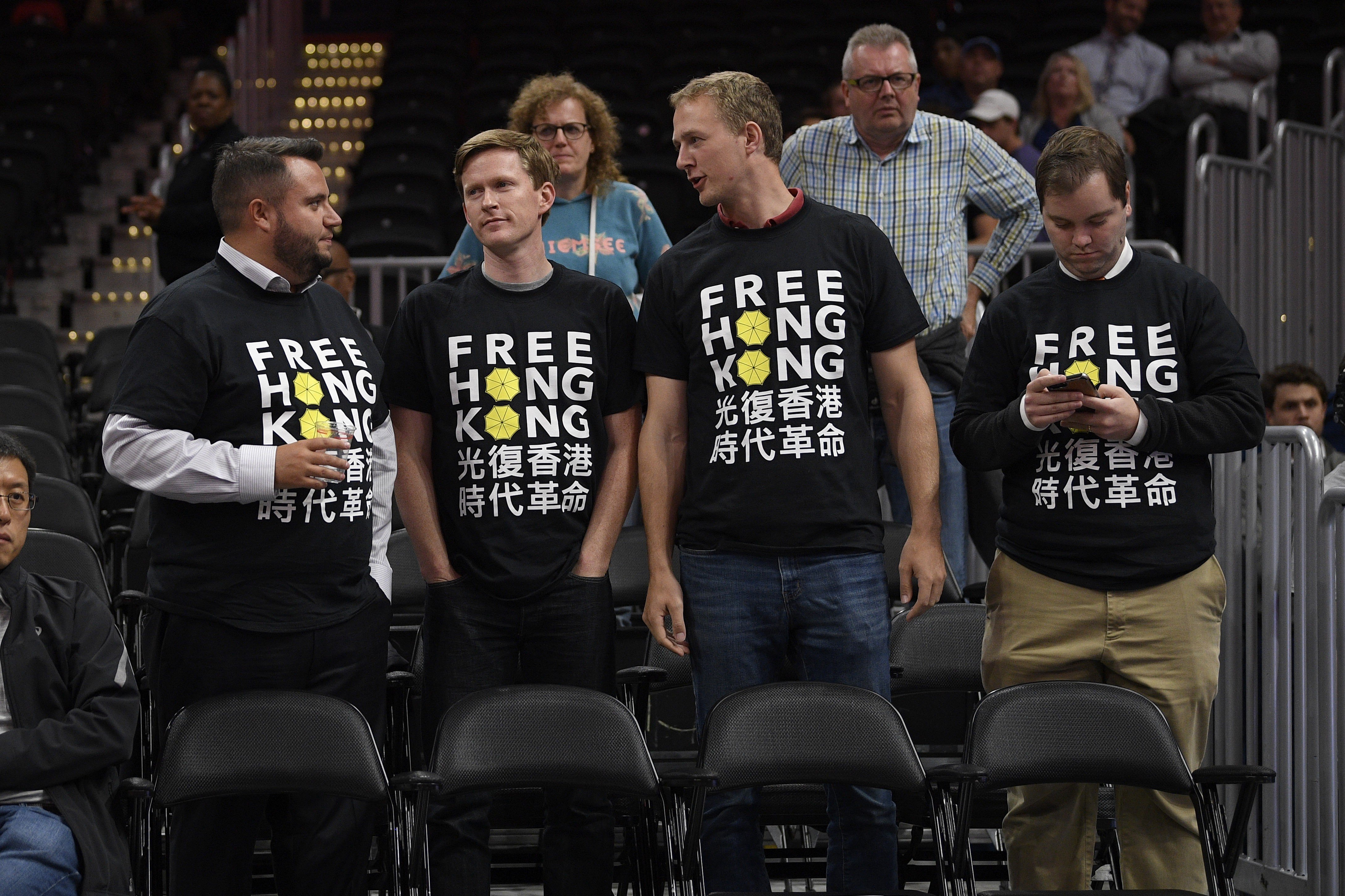 Activists wear “Free Hong Kong” T-shirts before an NBA exhibition game between the Washington Wizards and the Guangzhou Loong-Lions on October 9 in Washington. Photo: AP