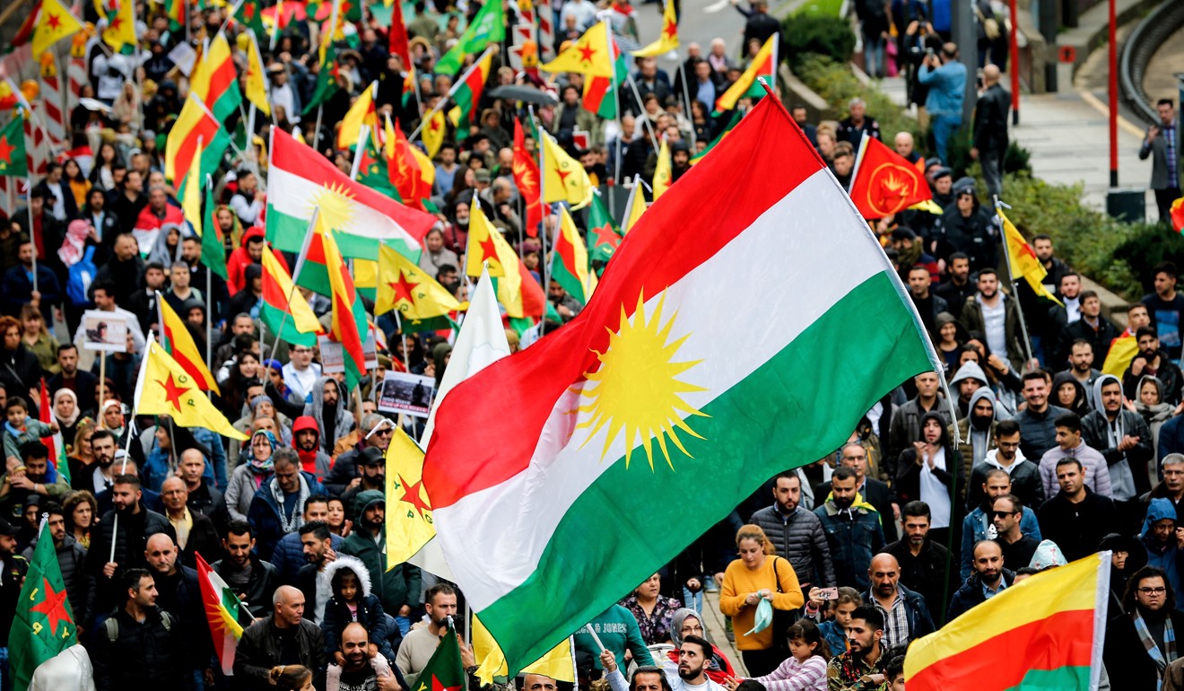 Activists wave flags and show banners as they protest against the ongoing Turkish military operation in the Syrian border region and the Kurdish territories, in Cologne. Photo: EPA-EFE