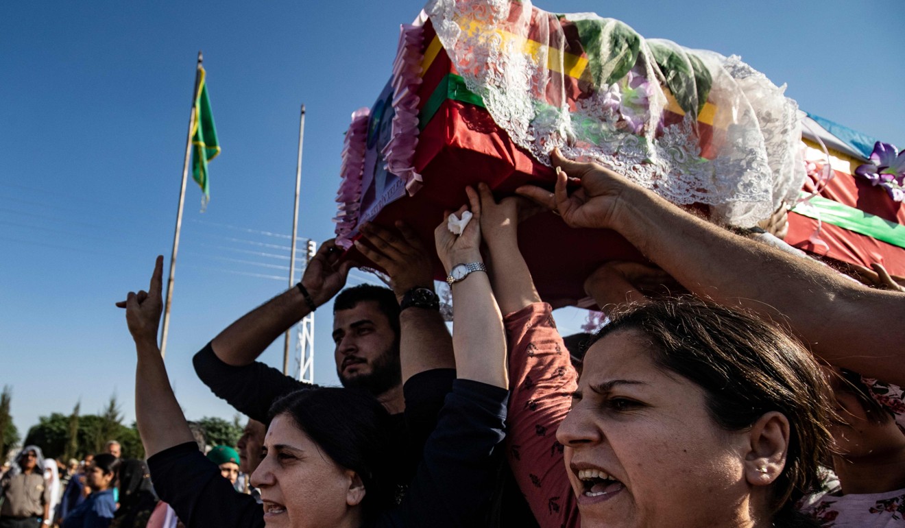 Mourners carry the coffin of Kurdish political leader Hevrin Khalaf during a funeral. Photo: AFP