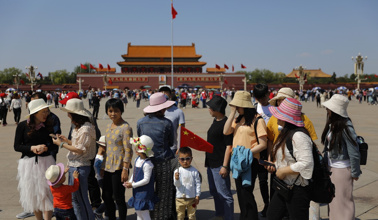 Chinese tourists visit Tiananmen Square in Beijing. Analysts say 782 million people opted for “staycations” at local historical sites over golden week this year. Photo: EPA