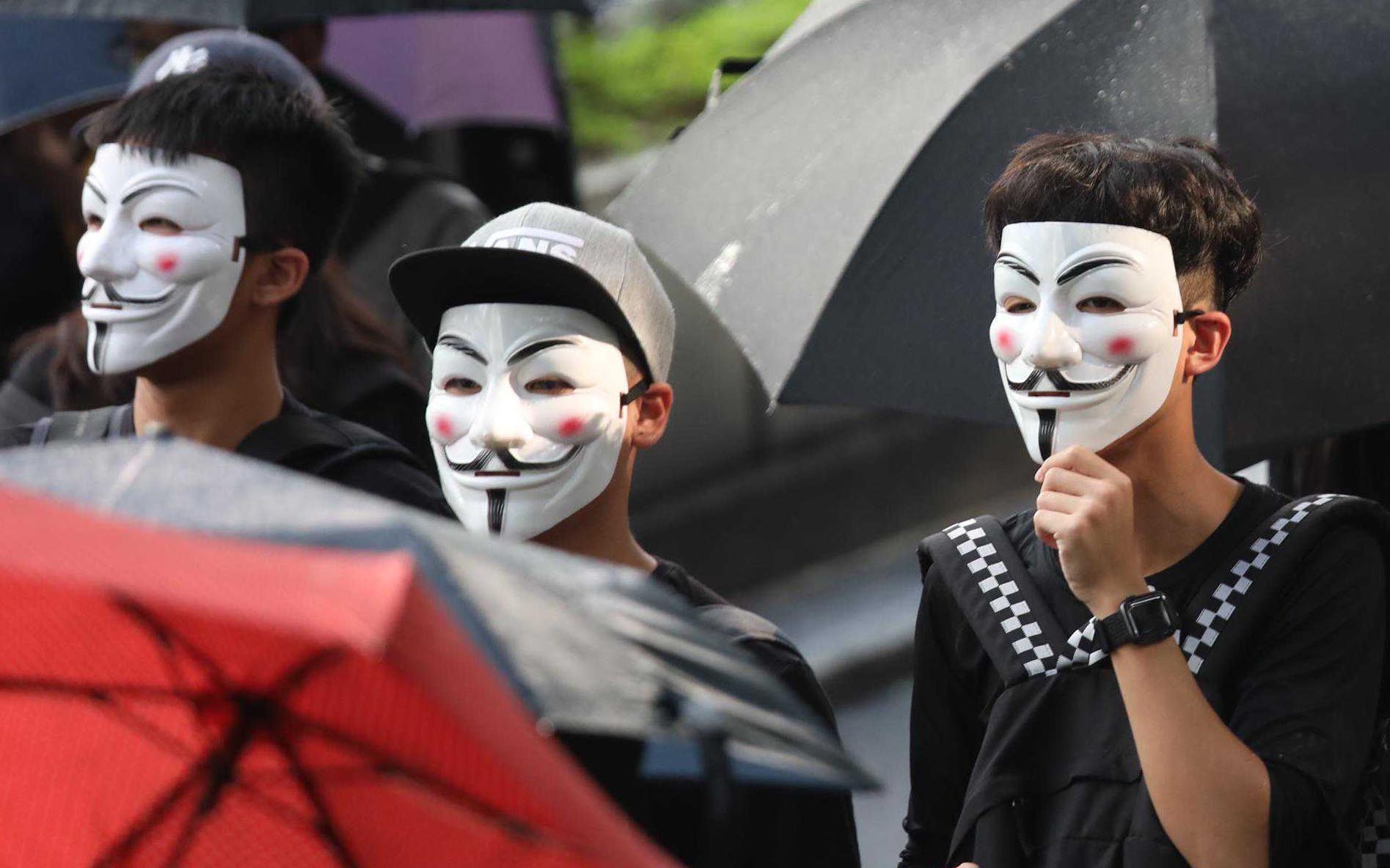 Protesters march with their masks on. Photo: Xiaomei Chen