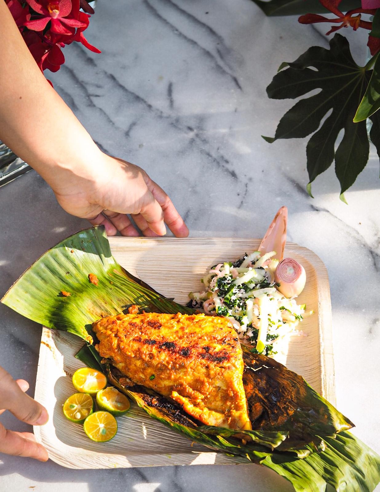 Barramundi with turmeric, galangal, lemongrass served with torched ginger, coconut, and apple slaw at a Once Upon A Secret Supper event in Singapore. Photo: Elodie Bellegrade