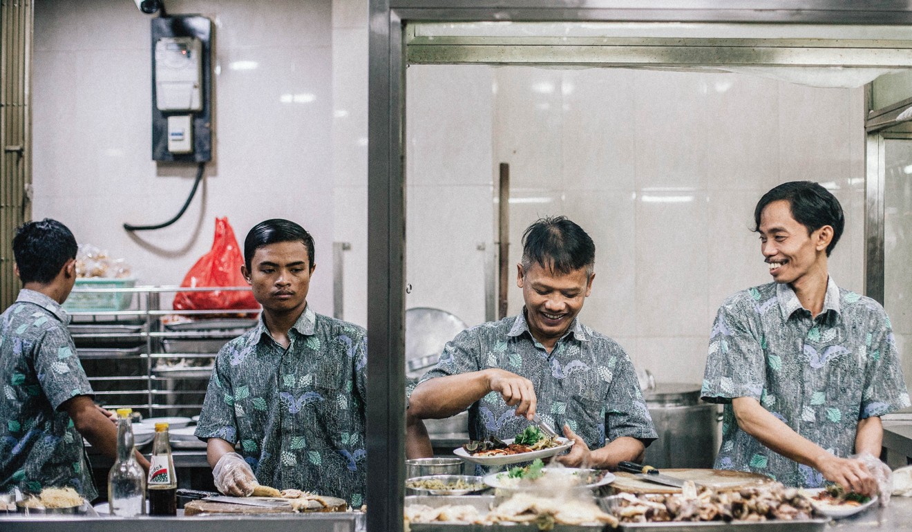 Kitchen staff prepare chicken congee at Bubur Ayam Mangga Besa. Photo: Agoes Rudianto