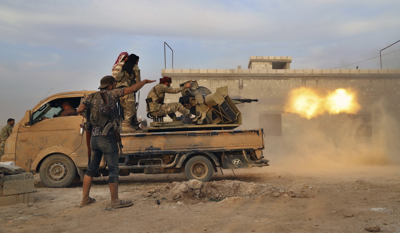 Turkey-backed Syrian opposition fighters fire a heavy machine-gun towards Kurdish fighters. Photo: AP