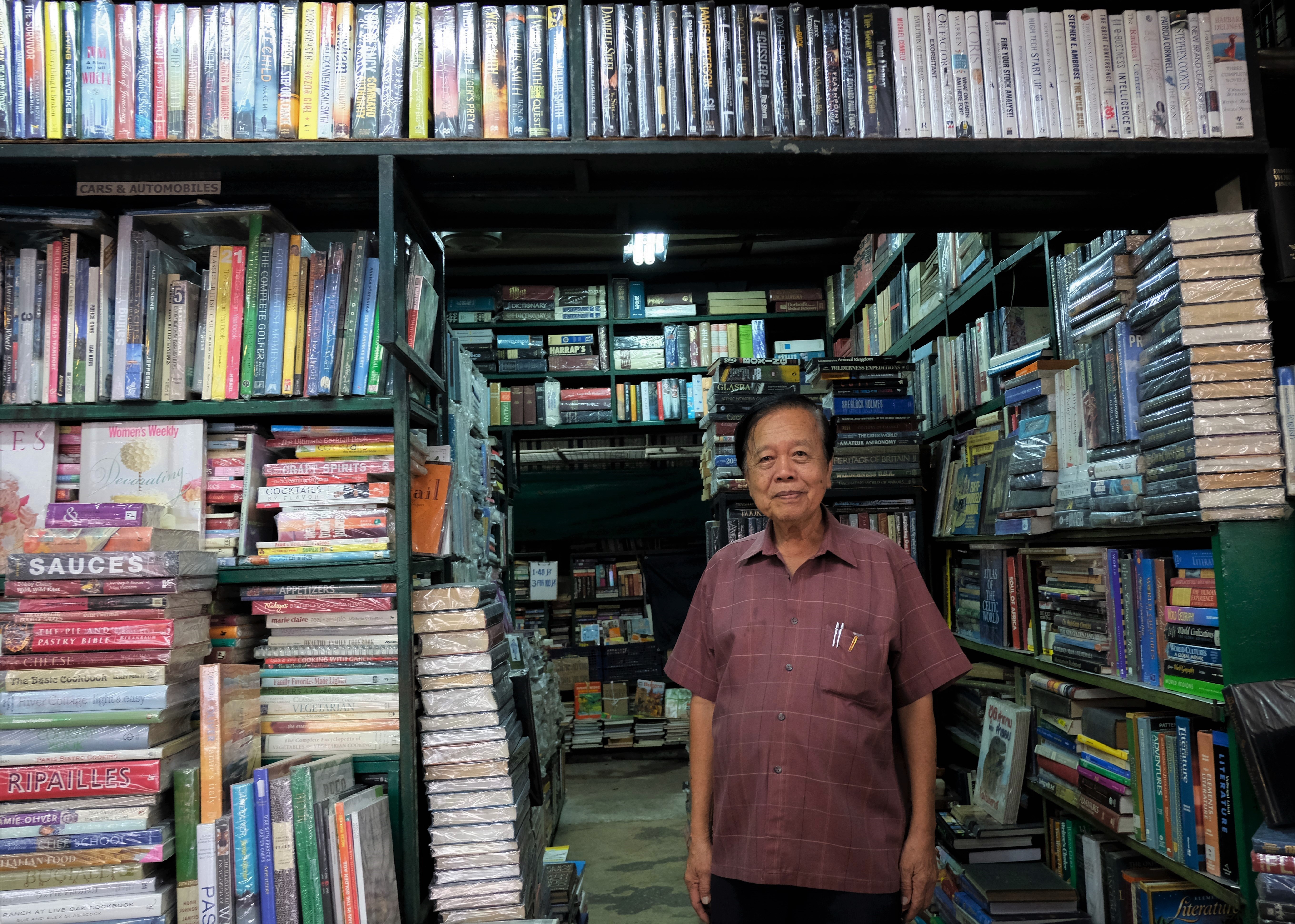 The “godfather of the second-hand book industry” Dilok Suengsoonthorn, the Thai-Chinese owner of Dilok Book at the Chatuchak Weekend Market in Bangkok, Thailand. Photo: Tibor Krausz