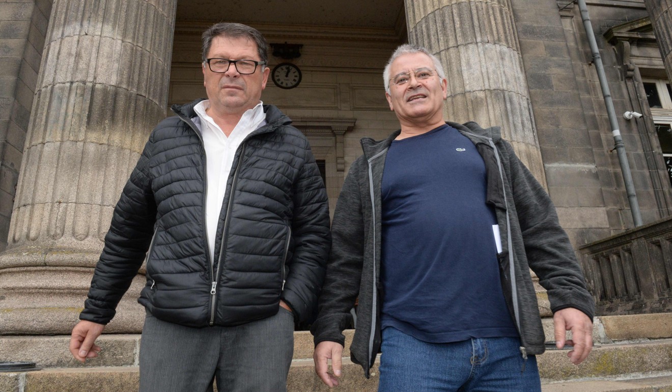 Mechanics Denis Latour (left) and Joachim De Souza, from the garage where the child was found, leave court during the appeal trial of Rosa Maria Da Cruz on October 7. Photo: AFP