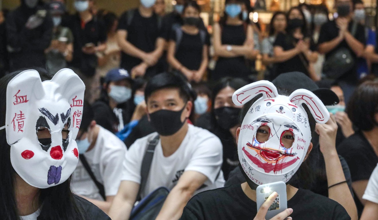 Anti-government protesters wearing masks at New Town Plaza in Sha Tin. Photo: Felix Wong