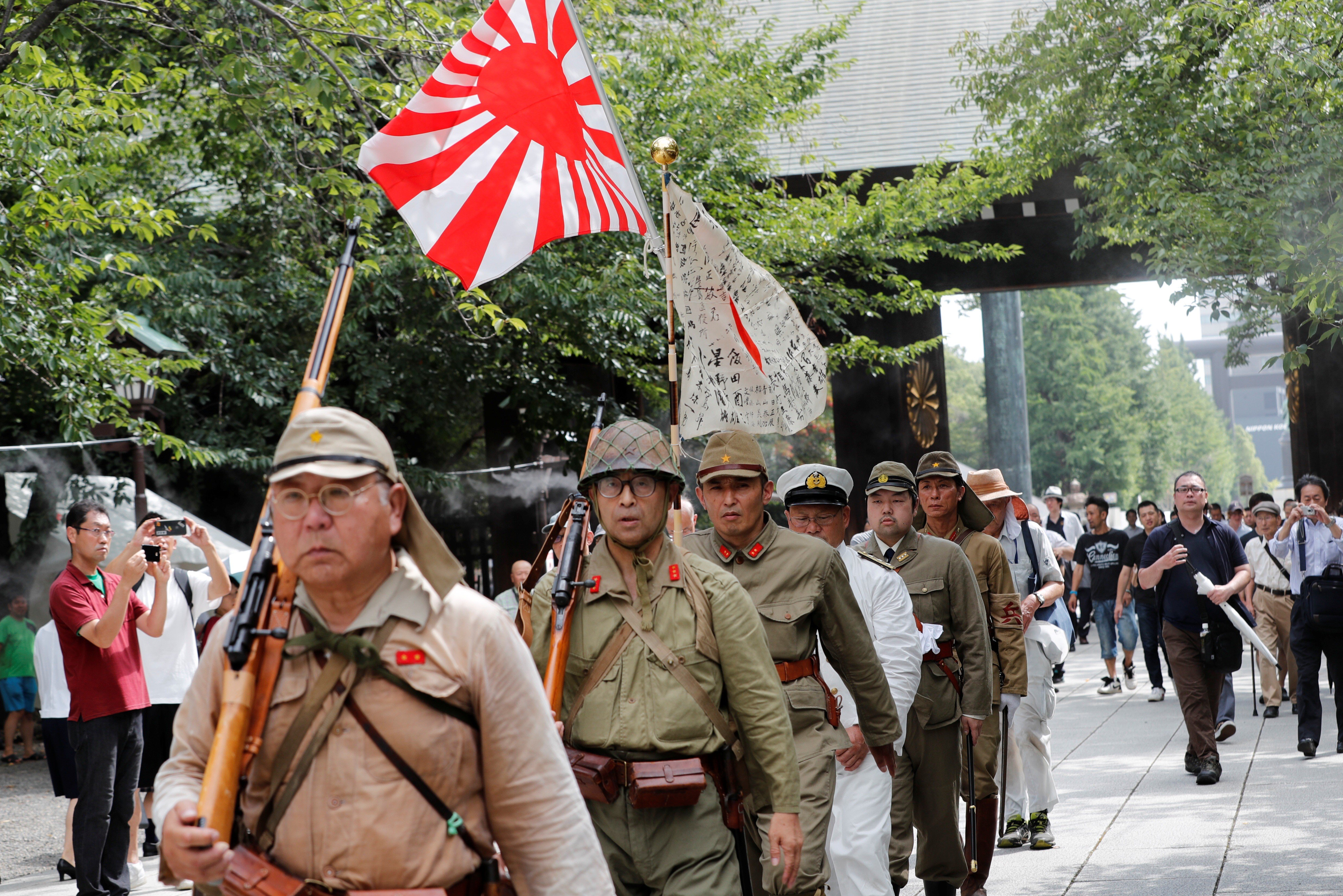 Men wearing Japanese imperial military uniforms visit the Yasukuni Shrine in Tokyo on August 15 for the 74th anniversary of their nation’s surrender in World War Two. Photo: Reuters