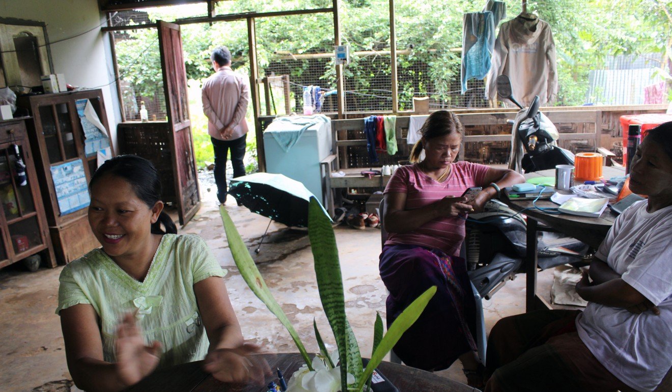 A group of women displaced by the Myitsone project gather at the home of Ja Hkawn in Aung Myithar village. Photo: Oliver Slow