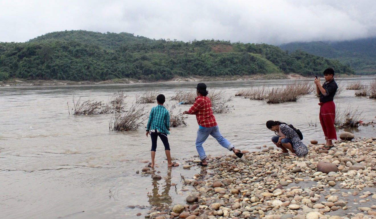 Children gather at the confluence of the Mali and N’Mai rivers, which forms the Irrawaddy River, Myanmar’s largest waterway. Photo: Oliver Slow