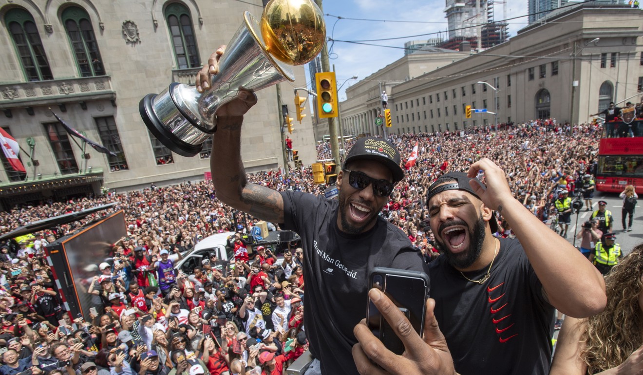 Kawhi Leonard holds his MVP trophy while celebrating with rapper/producer Drake during the Toronto Raptors’ NBA championship parade in Toronto. Photo: AP