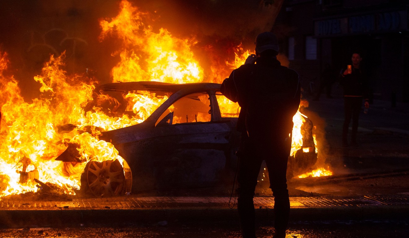 A car burns during violent protests in Santiago. Photo: AFP
