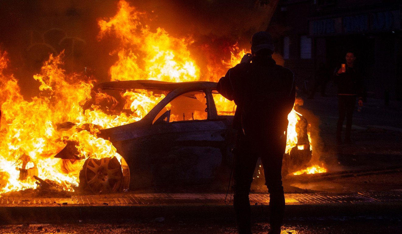 A car burns during violent protests in Santiago. Photo: AFP