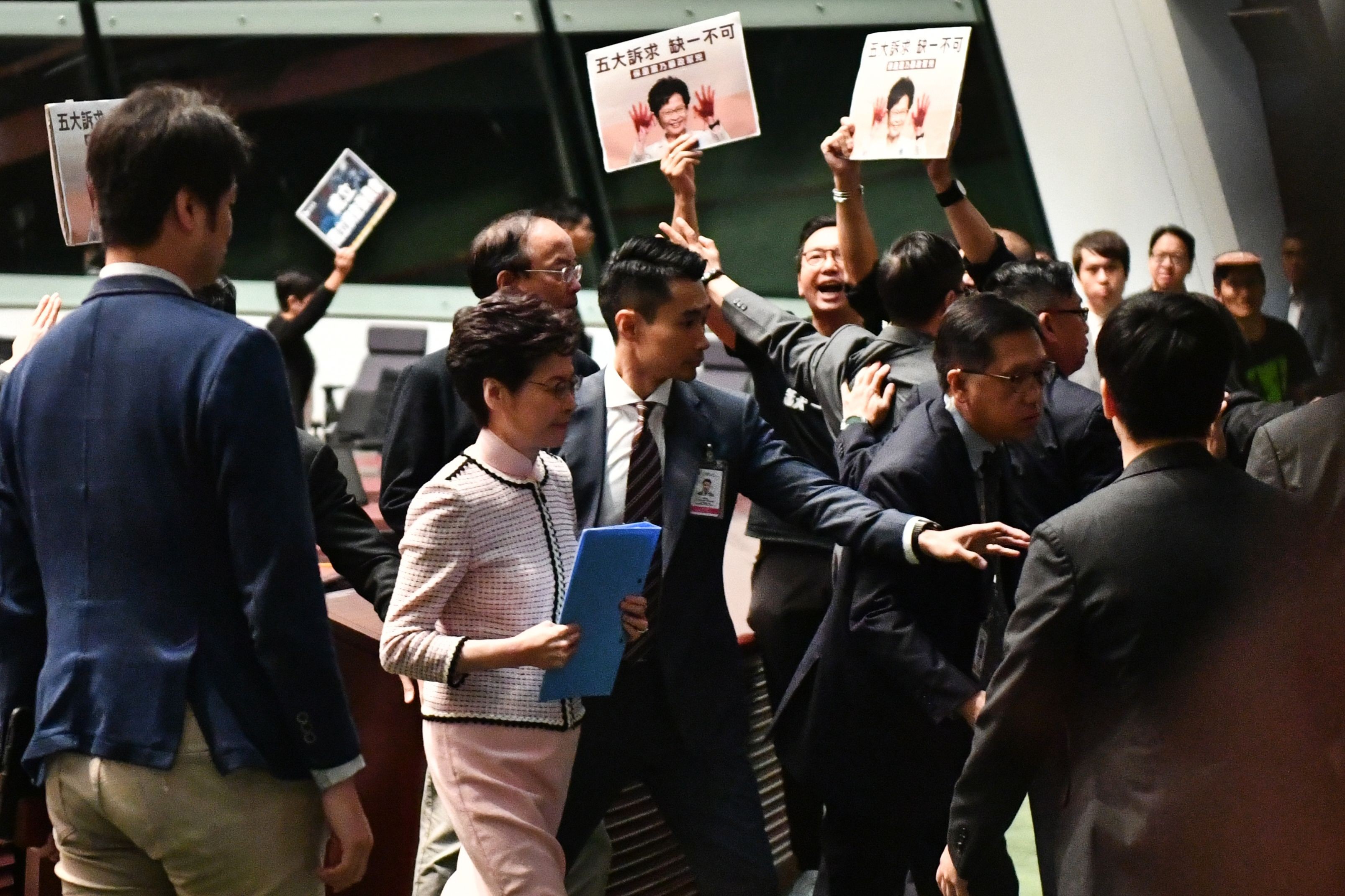 Chief Executive Carrie Lam leaves the Legislative Council chamber for a second time, as heckling opposition lawmakers thwart her attempts to deliver the annual policy address on October 16. The address was eventually delivered by video. Photo: AFP