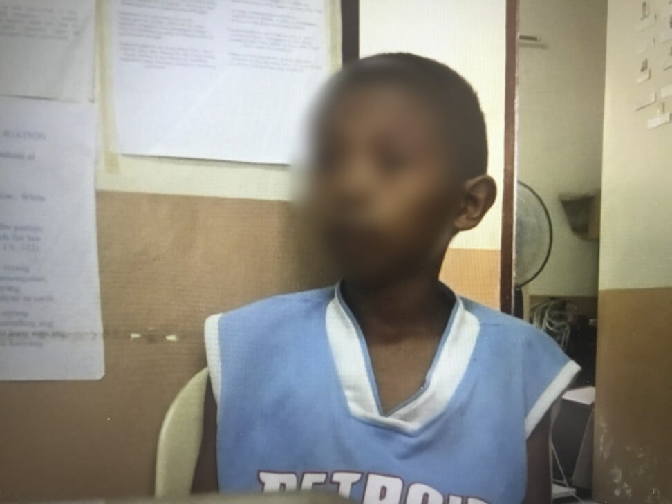 10-year-old “Christian” at a police station in Angeles City giving a statement against Slade soon after he was abused by him. Photo: Red Door News
