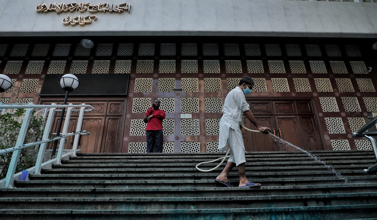 A clean-up operation was underway at Kowloon Mosque after its frontage was covered in blue dye fired from police water cannons. Photo: SCMP