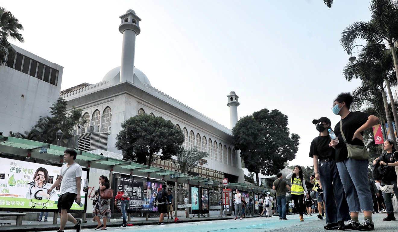Volunteers help clean up Kowloon Mosque after a police water cannon sprayed the building with blue dye to disperse anti-government protesters. Photo: Handout