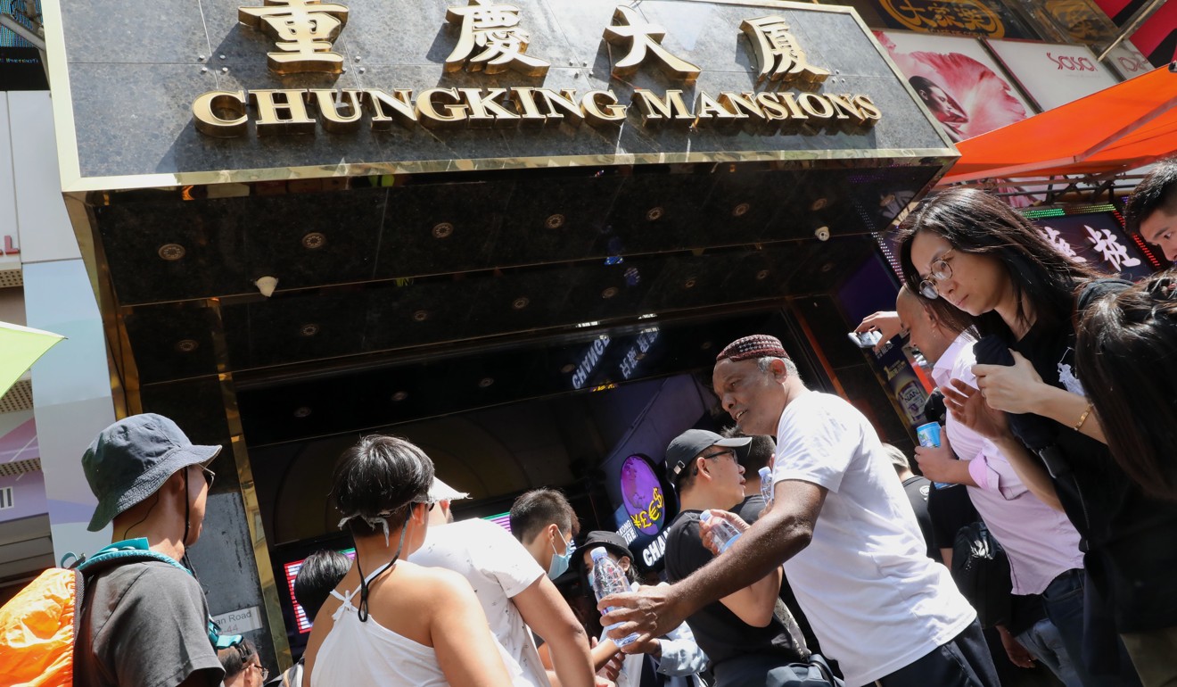 Supporters pass out water bottles to protesters outside Chungking Mansions on Nathan Road on Sunday.Photo: K.Y. Cheng