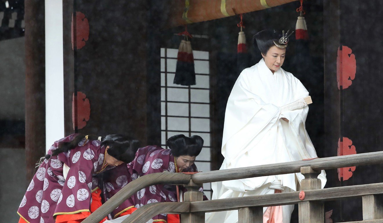 Empress Masako, right, leaves the Kashikodokoro sanctuary where Emperor Naruhito reported his enthronement to his ancestors. Photo: AFP