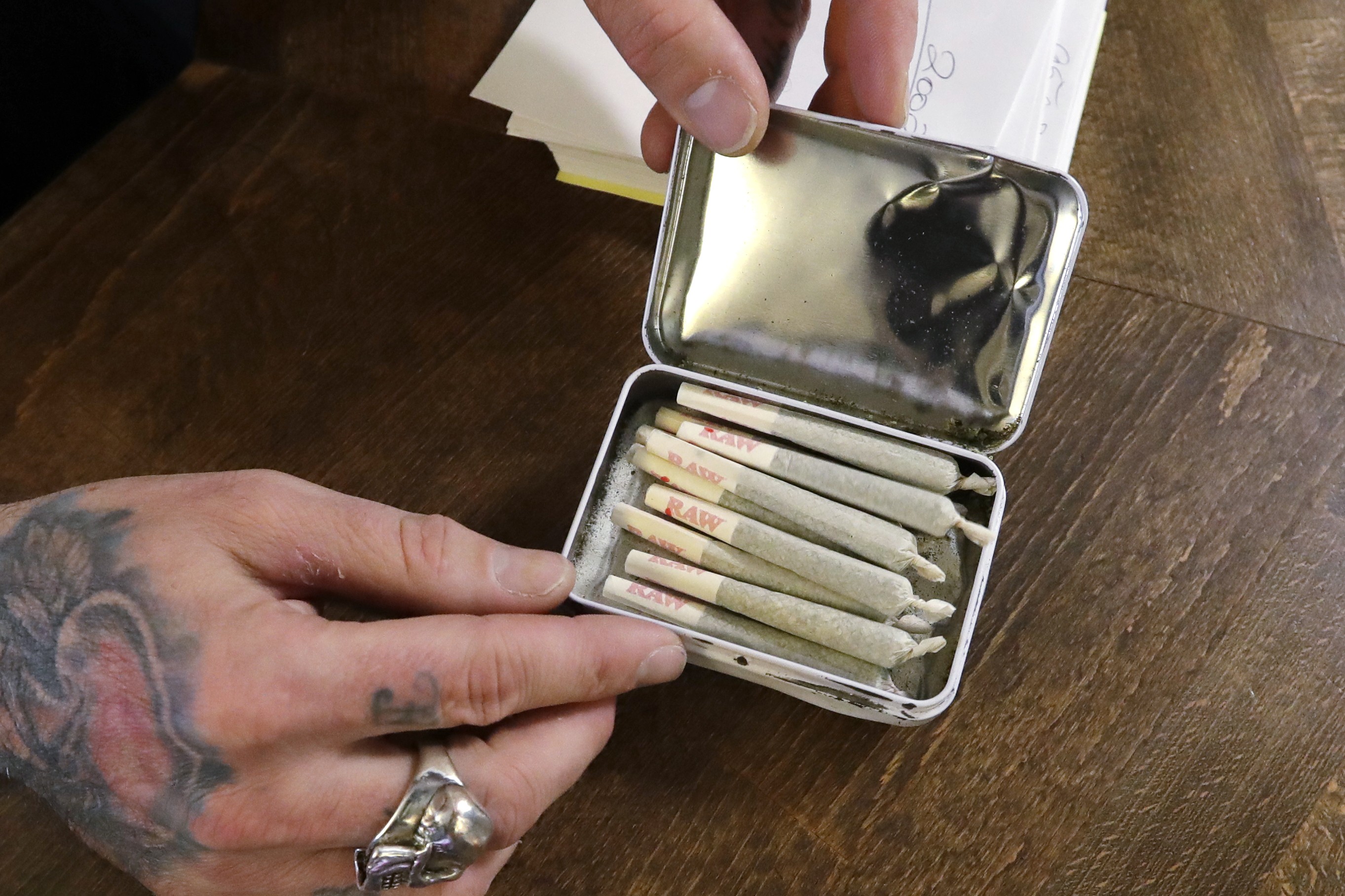 A clerk packs pre-rolled marijuana joints for a customer in Vancouver. The legalisation of cannabis abroad, in jurisdictions including Canada, is said to be encouraging Hong Kong youngsters to try the drug without fully realising the possible health consequences. Photo: AP