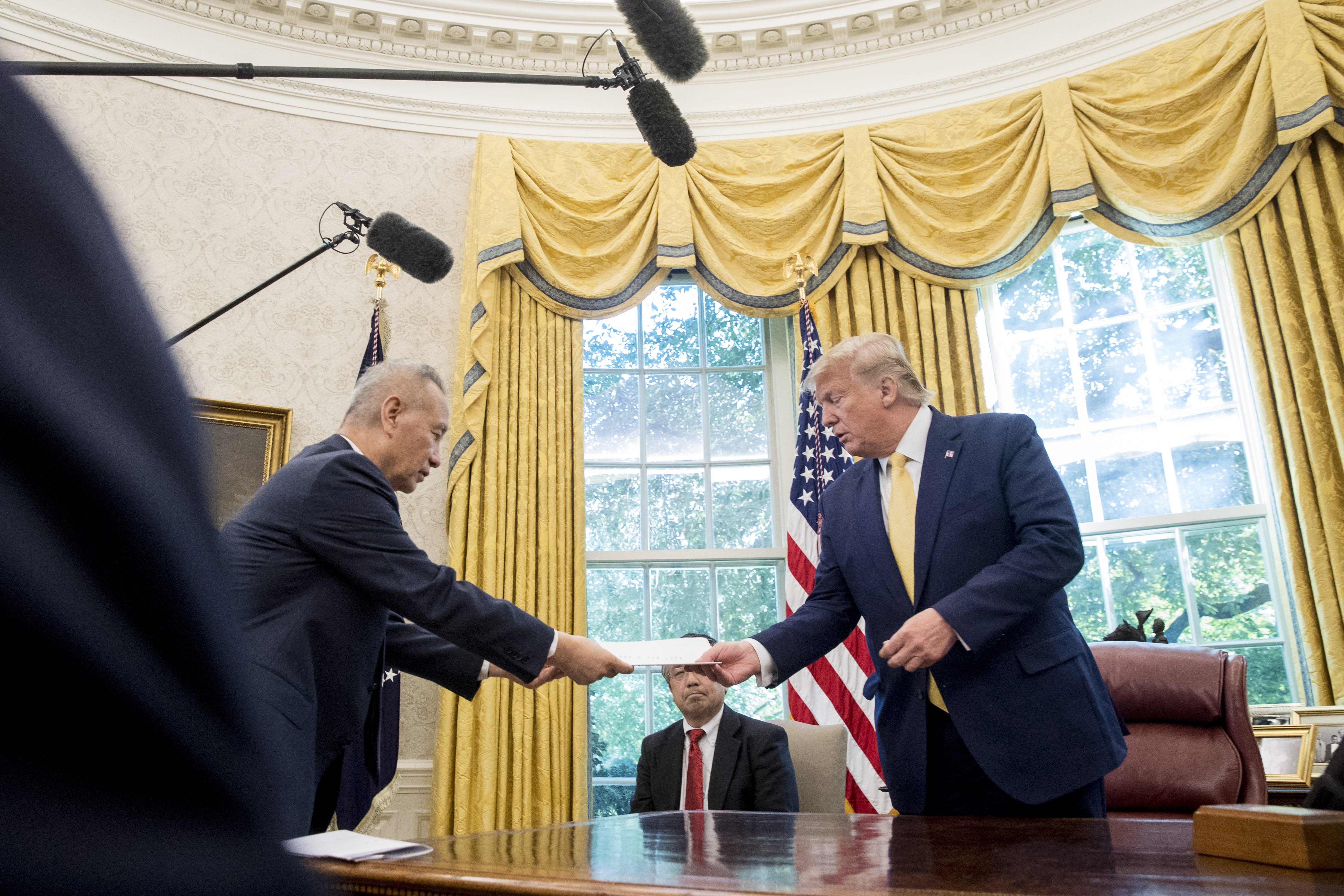 US President Donald Trump receives a letter presented to him by Chinese Vice-Premier Liu He in the Oval Office of the White House on October 11. Photo: AP