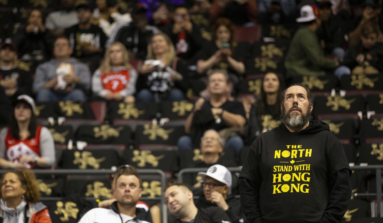 A fan wears a T-shirt handed out by Hong Kong pro-democracy supporters, at the Toronto Raptors game. Photo: AP
