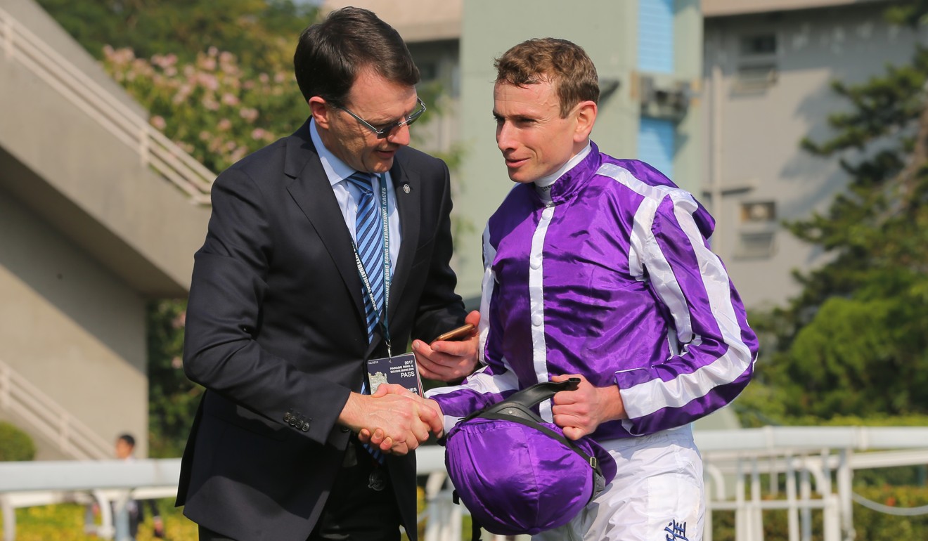 Trainer Aidan O'Brien with jockey Ryan Moore after winning the Hong Kong Vase.