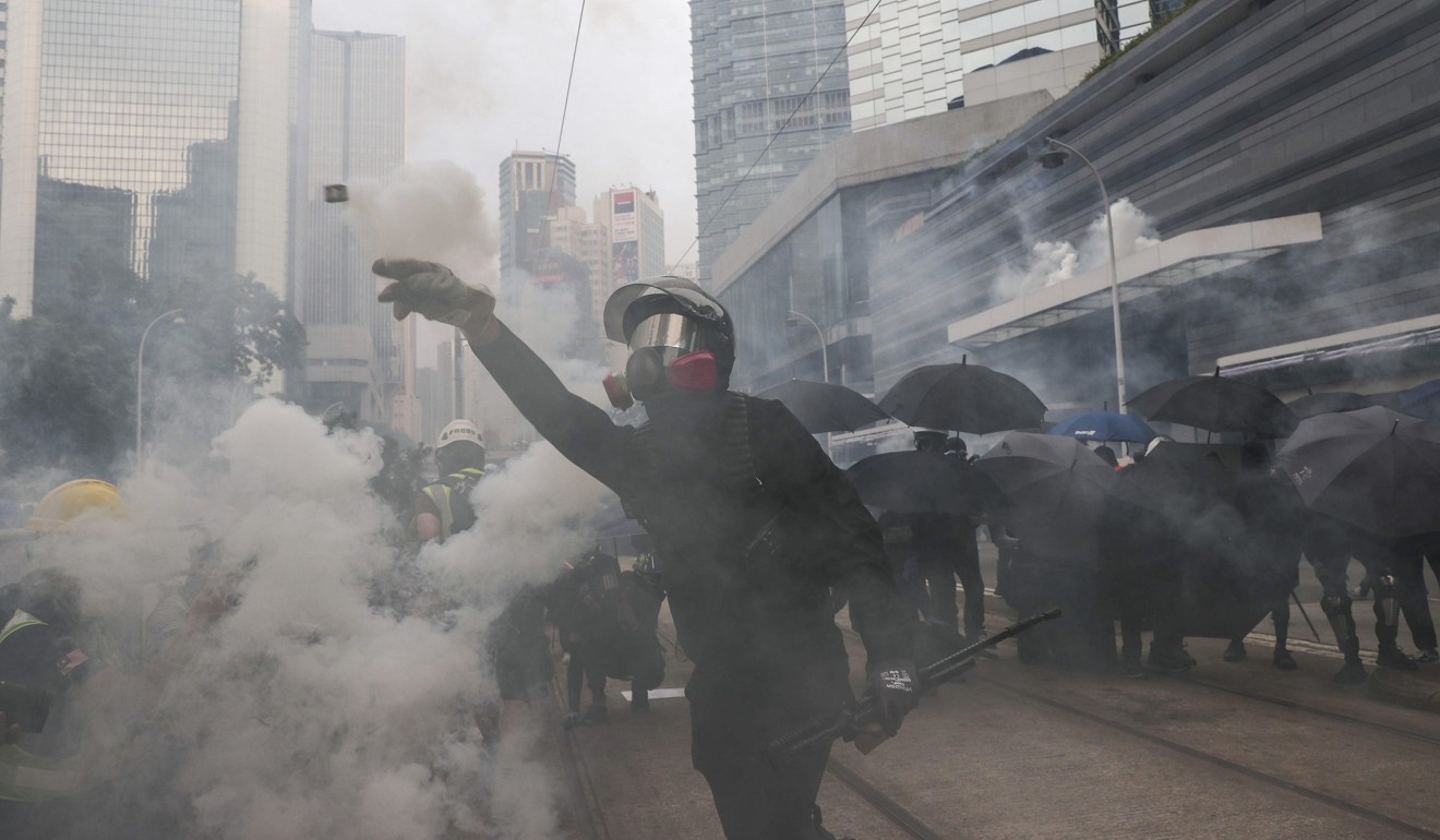 Riot police fire tear gas on protesters in Admiralty as they gather for an anti-extradition bill march from Causeway Bay. Photo: Sam Tsang