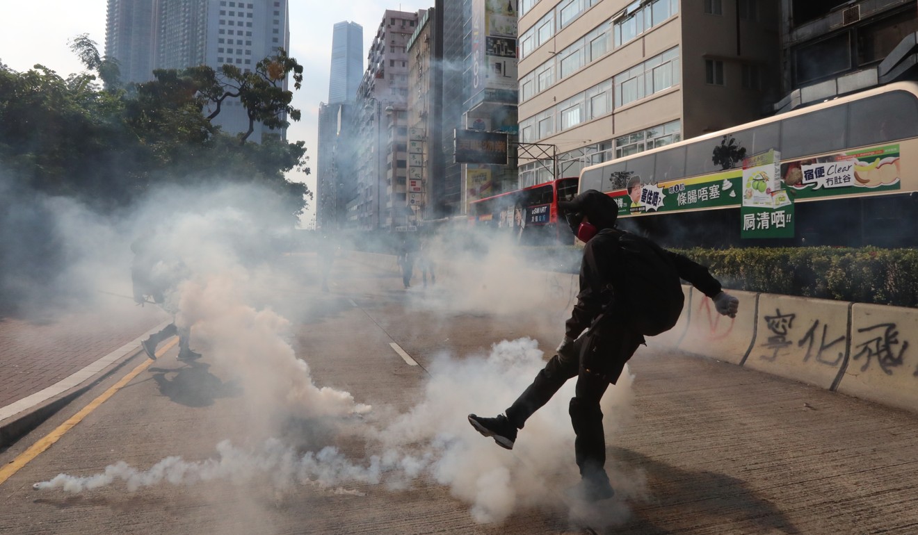 Young protesters have become adept at dealing with tear gas fired by police. Photo: Felix Wong