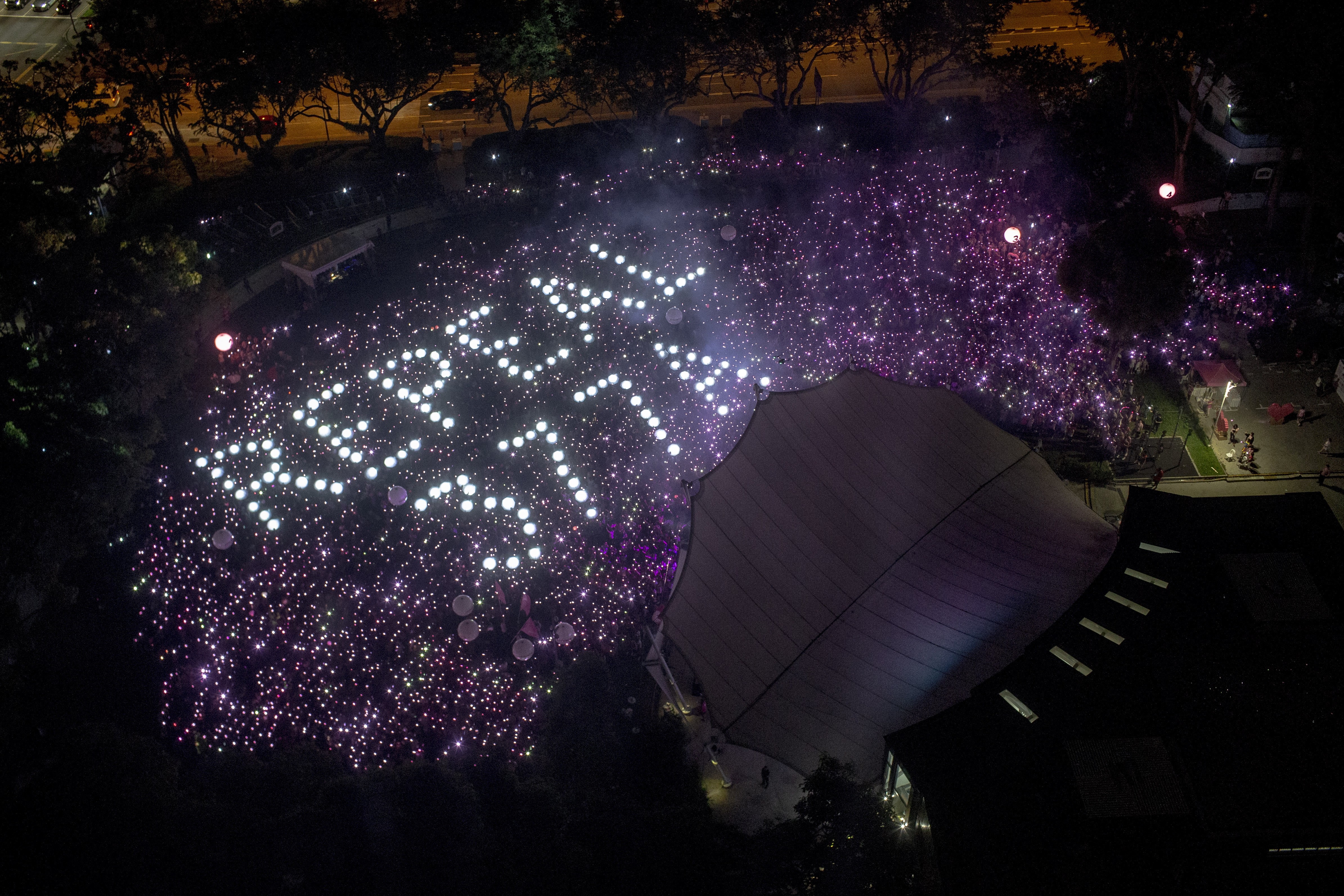 The words “Repeal 377A”, referencing a law that criminalises sexual acts between men, are formed by the crowd during the Pink Dot festival at Speaker's Corner in Hong Lim Park, Singapore, on June 29. Photo: EPA-EFE