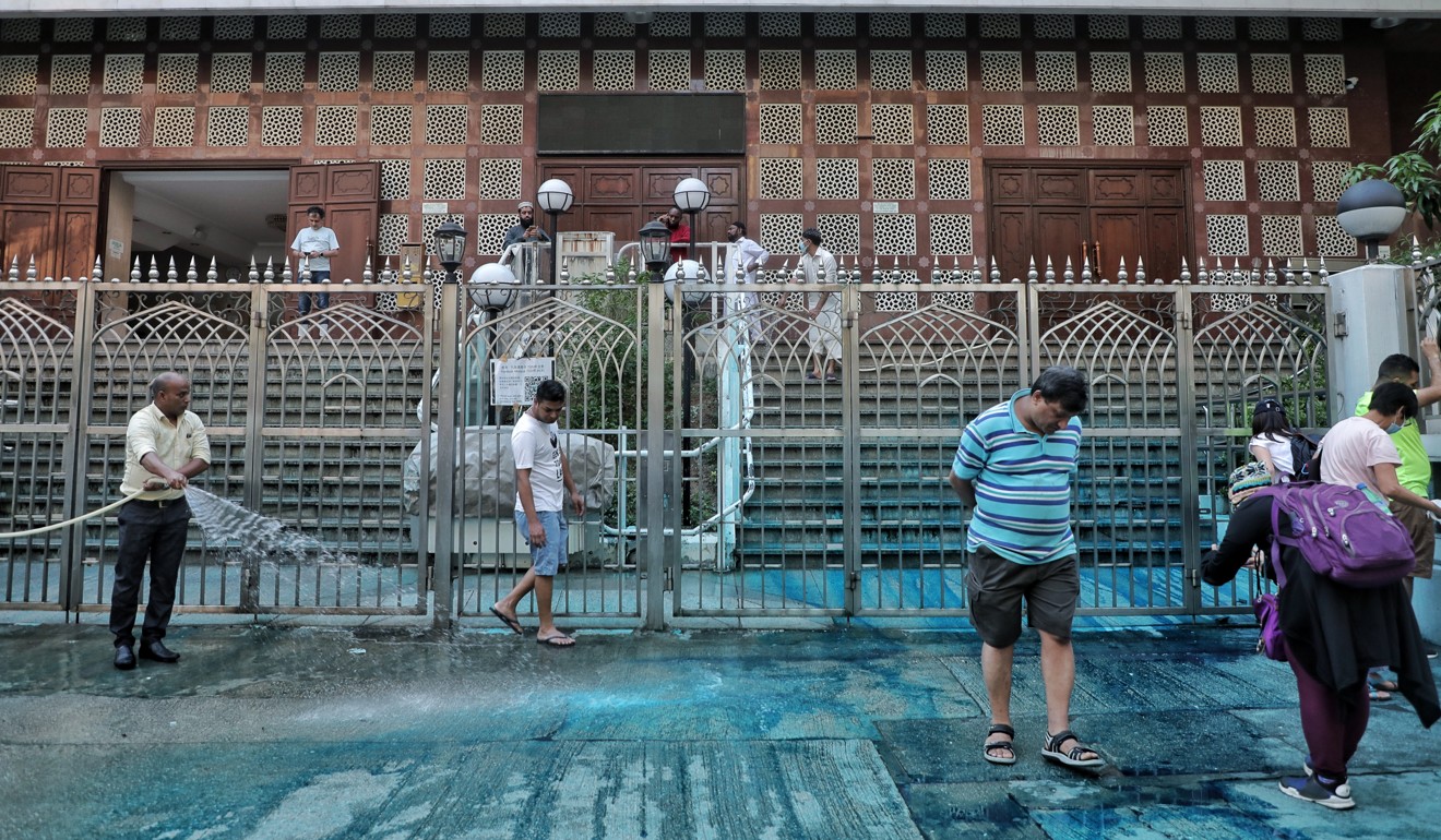 Volunteers clean up Kowloon Mosque in Tsim Sha Tsui on Sunday after a police water cannon sprayed the building’s entrance with blue-dyed water. Photo: Handout