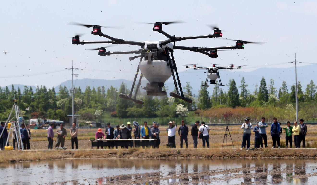 Drones demonstrate seeding in a rice paddy near an agriculture technology centre in South Korea. Photo: EPA
