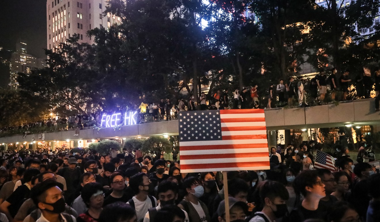 Protesters holding US flags march in Hong Kong’s Central district on October 14 in support of a pro-democracy bill being debated in the US Congress. Photo: EPA-EFE
