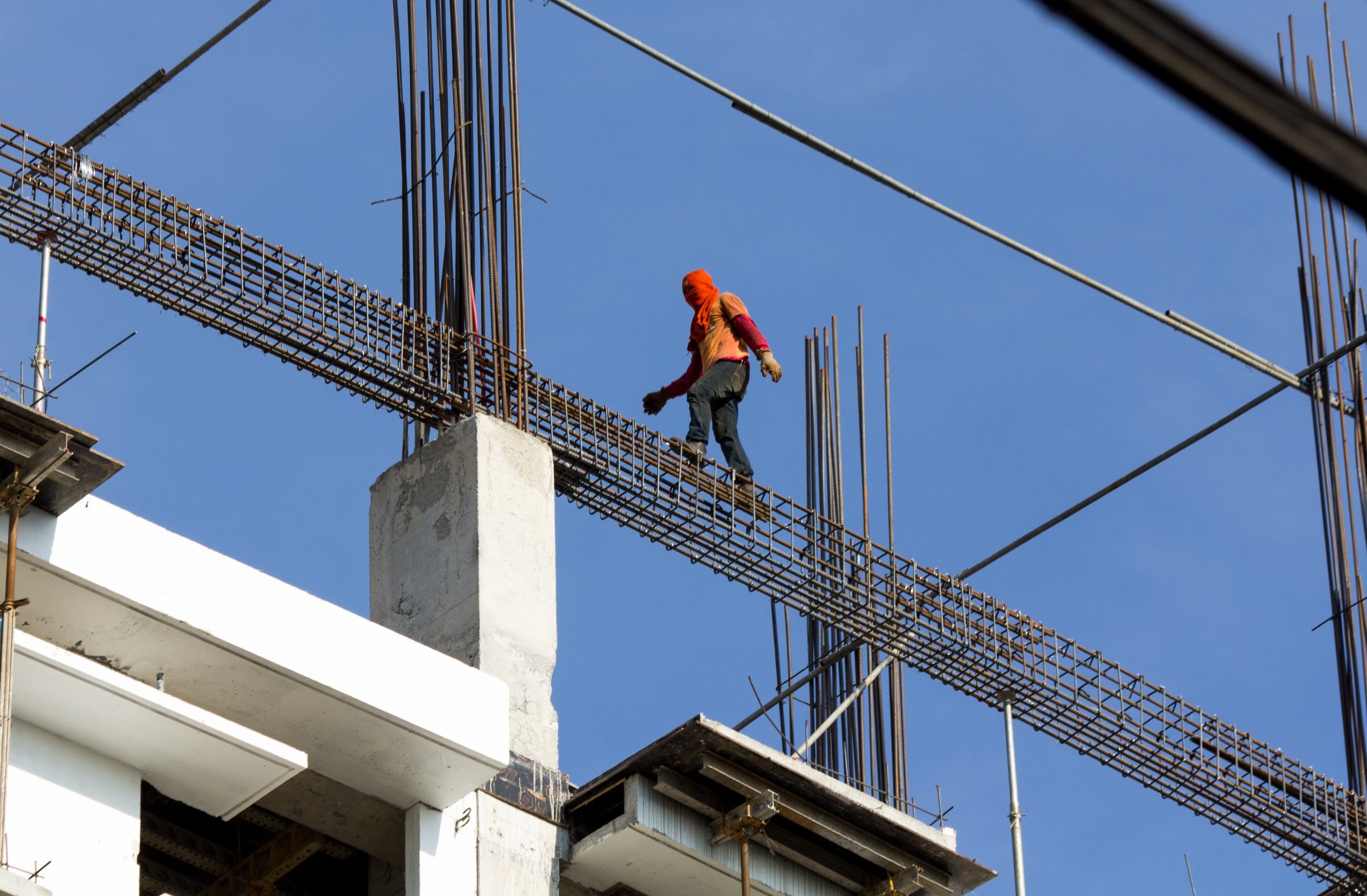 A worker fearlessly walks along steel reinforcement bars at a construction site in Manila. Photo: Getty Images/iStockphoto
