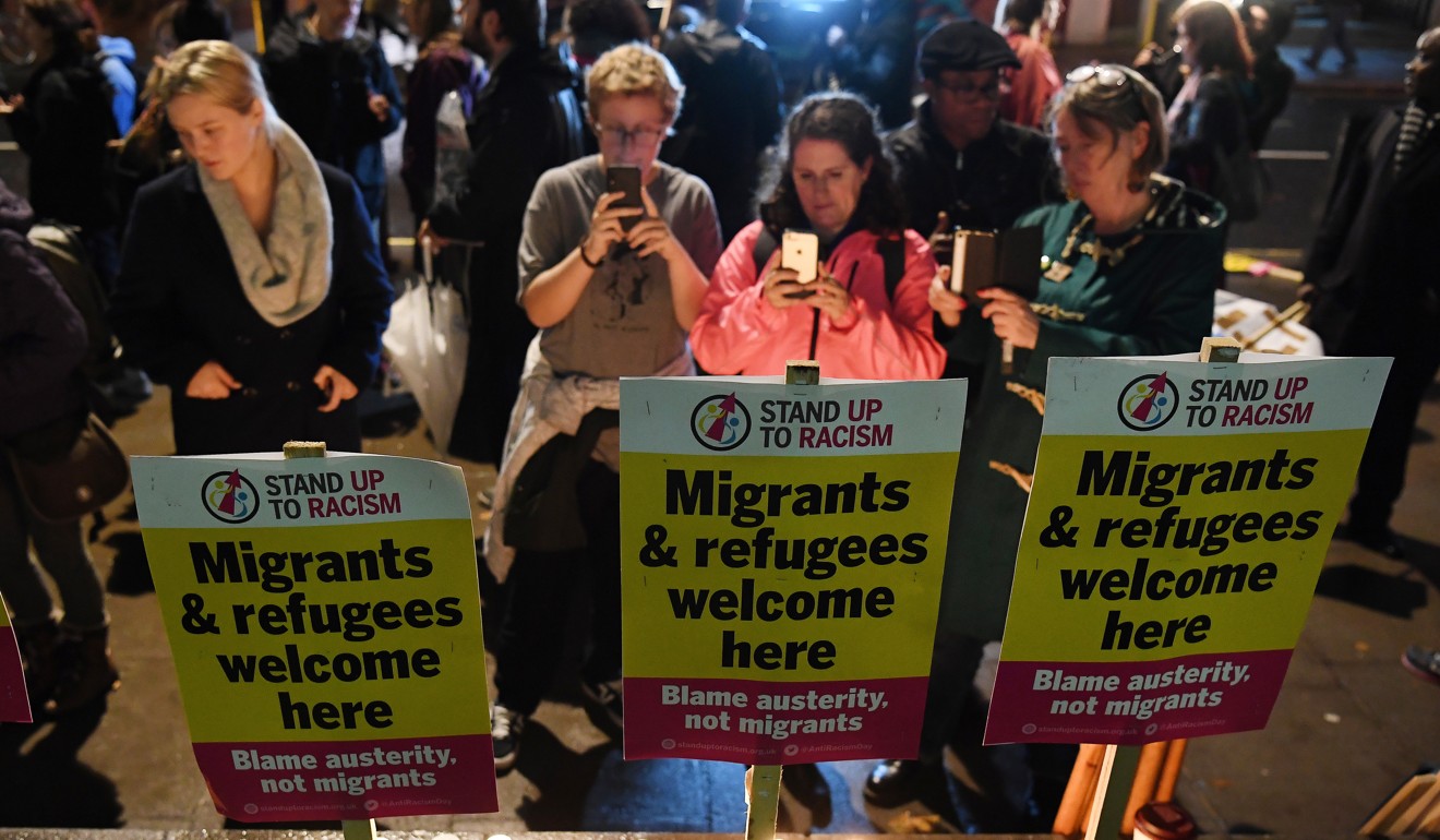 People hold a vigil for the truck death victims in London. Photo: EPA