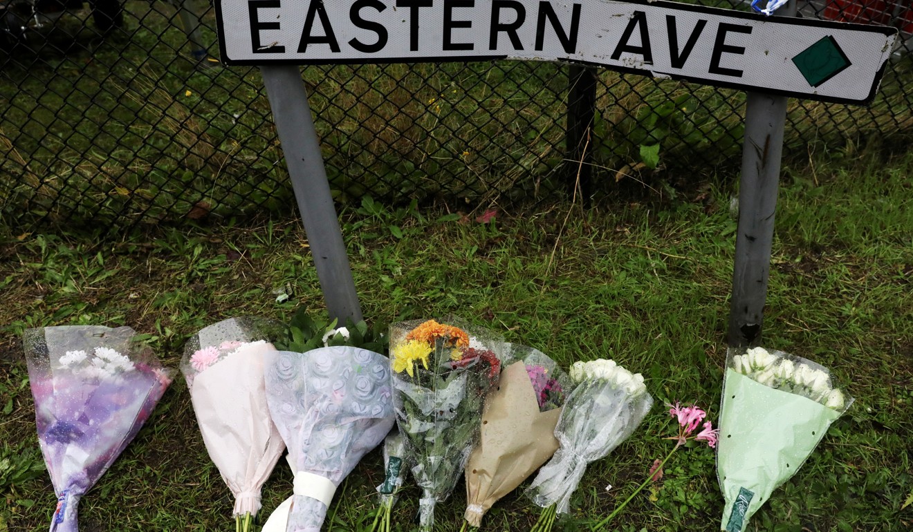 Flowers are seen on Thursday at the scene where bodies were discovered in a truck container, in Grays, Essex. Photo: Reuters