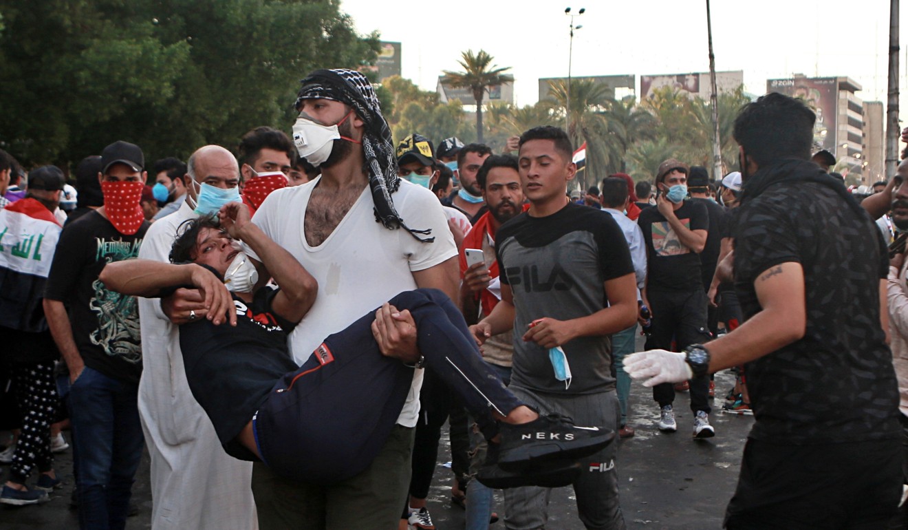An injured protester is rushed to a hospital during a demonstration in Baghdad. Photo: AP