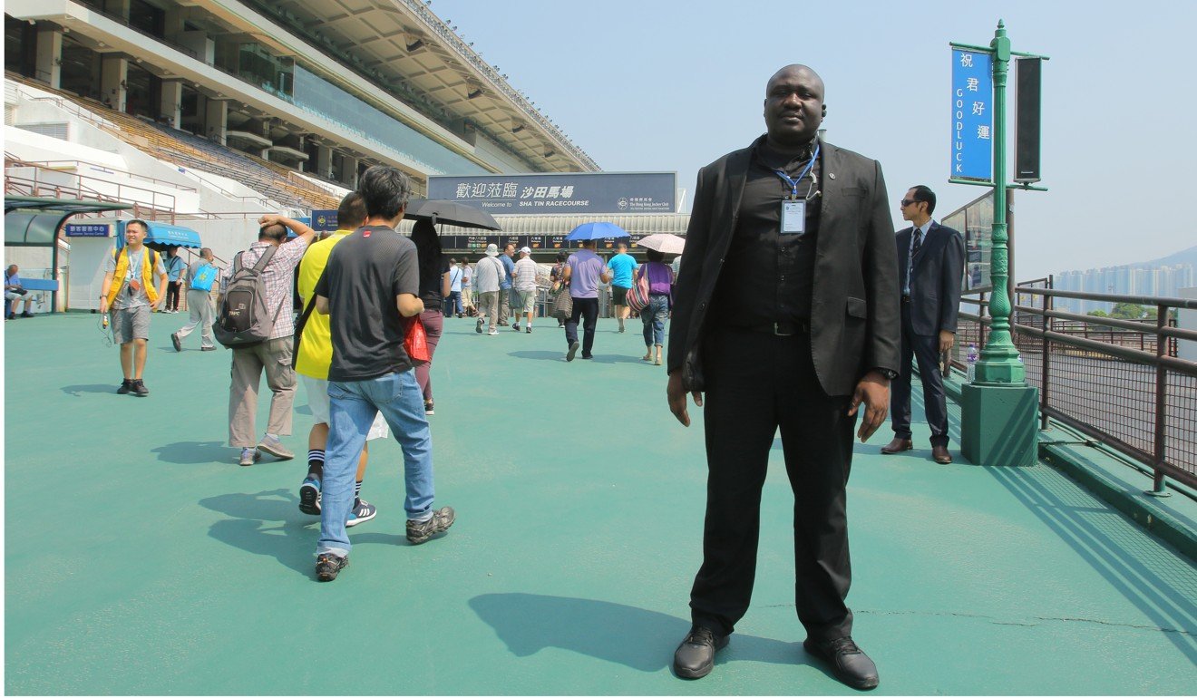 A security guard stands watch outside Sha Tin on October 1.