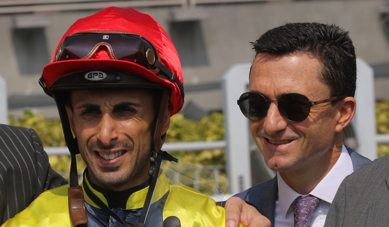 Jockey Alberto Sanna celebrates a winner with trainer Douglas Whyte at Sha Tin on Sunday.