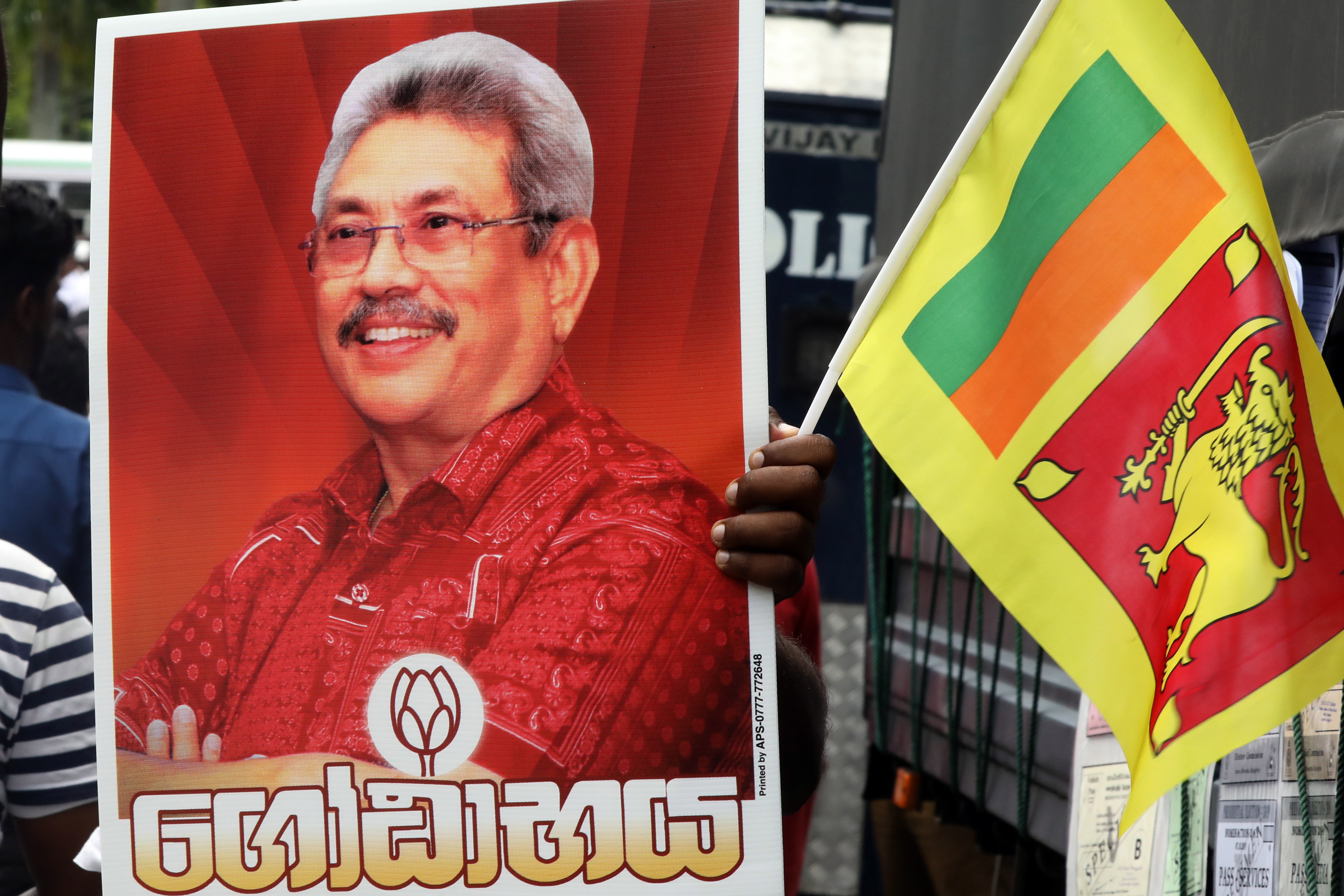 Sri Lanka Podujana Peramuna supporters hold a poster of presidential front runner Gotabhaya Rajapaksa. Photo: EPA