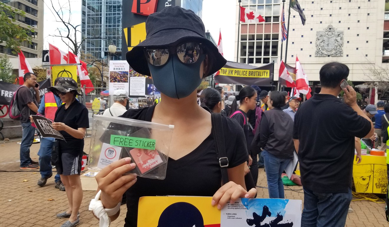 A protester who moved to Vancouver from Hong Kong a few months ago takes part in a demonstration backing the Hong Kong protests outside the Vancouver Public Library in Canada. Photo: AFP